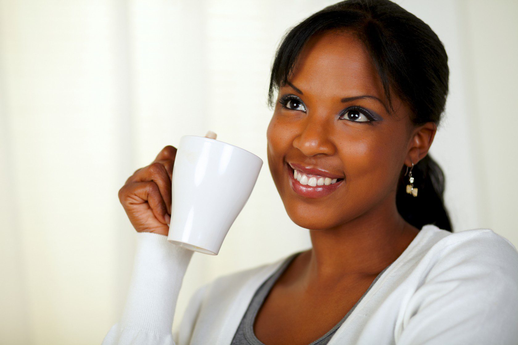 Attractive young woman drinking a cup of tea